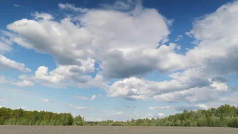 Serene Landscape Featuring a Beautiful Blue Sky Complemented by Fluffy White Clo Vídeo Stock 307745834