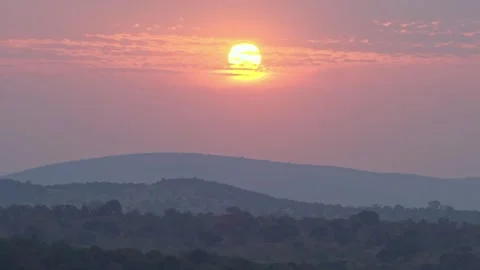 A serene landscape with sunlight through clouds, African Sunset in Rwanda Stock Footage 283707551