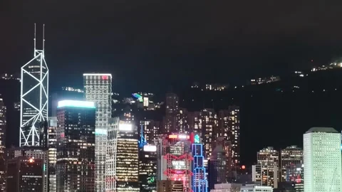 A serene low-angle shot of Hong Kong's iconic skyline at night, capturing the Stock Footage 338280369