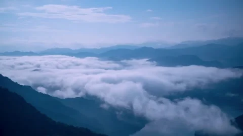 Serene Moonlight Over Rolling Clouds and Distant Mountains. Stock Footage 285861389