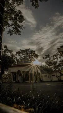 Serene Mosque at Sunset with Sun Rays Stock Photos