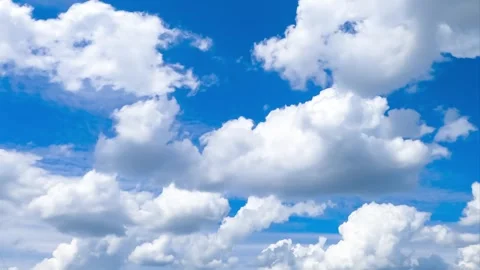 A serene motion of puffy white cumulus clouds dynamically drifting across a.. Stock Footage 337538541