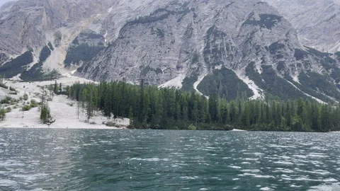 A Serene Mountain Lake that is Surrounded by a Lush Forest and Majestic Peaks Stock Footage 280767095