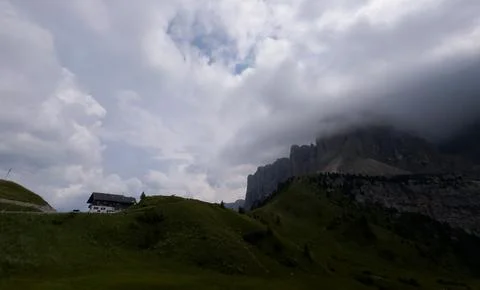 Serene mountain landscape with dramatic sky over rural area, low angle view.. Stock Photos