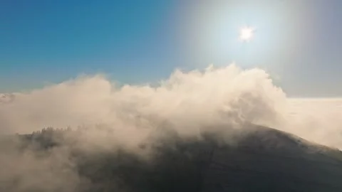 A Serene Mountain Landscape Featuring Fog Enhanced by Sunlight Stock Footage 320061253