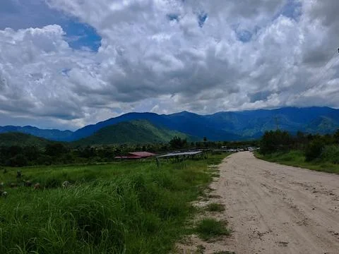Serene Mountain Landscape Under Dramatic Cloudy Sky Stock Photos