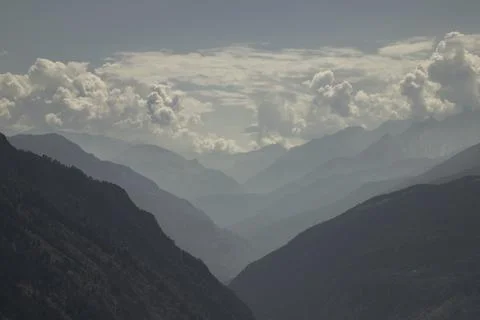 Serene mountain range creating layers of atmospheric haze Stock Photos