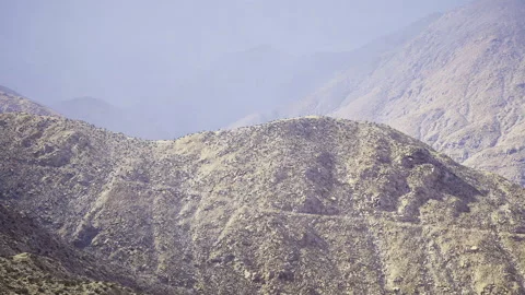 Serene mountain ridges dissolve into misty atmospheric effects Stock Footage 338340151