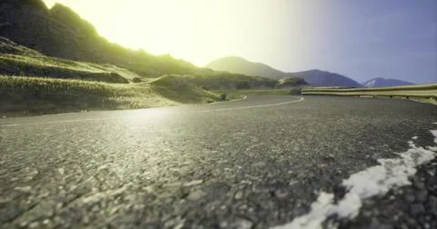 Serene mountain road winding through green hills under a bright sun Stock Illustration