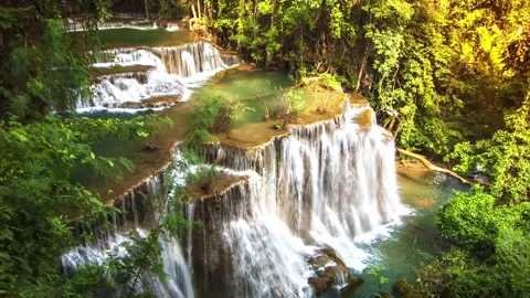 Serene Multi-Tiered Waterfall Cascading Through Lush Tropical Rainforest Stock Footage 301087481