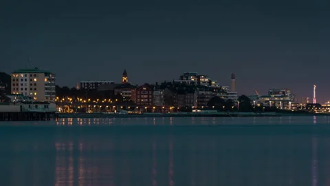 Serene Night Cityscape with Reflections Stock Footage 303644853