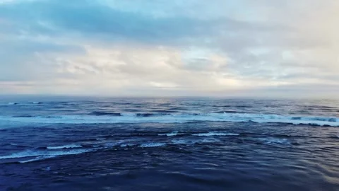 Serene Ocean Horizon with Soft Waves and Dramatic Clouds Stock Footage 337745420