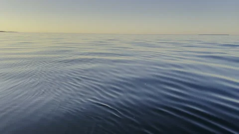 A Serene Ocean Surface at Dusk Under a Beautiful and Clear Sky Stock Footage 280566943