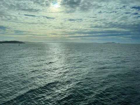 Serene ocean under cloudy sky Stock Photos