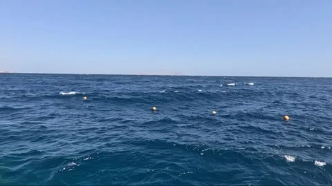 A Serene Ocean View Capturing Calm Waves and Buoys Floating Above Clear Waters 库存影片 330100543