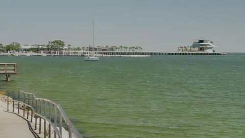 Serene ocean view featuring a pier extending into the water, surrounded by a pea Stock Footage 306883015