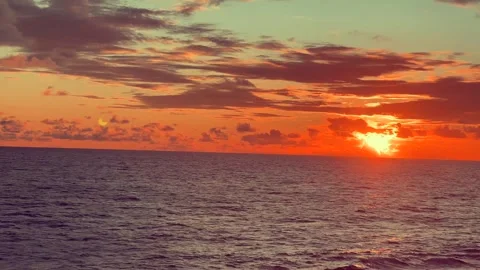 Serene ocean view at sunset with vibrant sky and clouds reflecting on calm .. Stock Footage 338281682