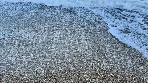 The Serene Ocean Waves are Gently Washing Ashore, Creating a Beautiful Scene Stock Footage 316781671
