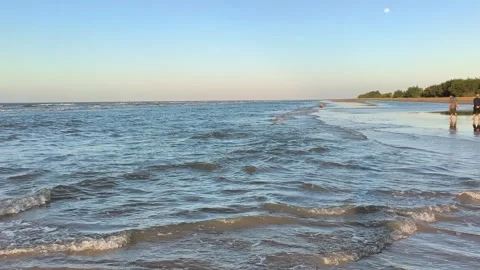 Serene Ocean Waves Crashing on Sandy Beach at Golden Hour Stock Footage 340489573
