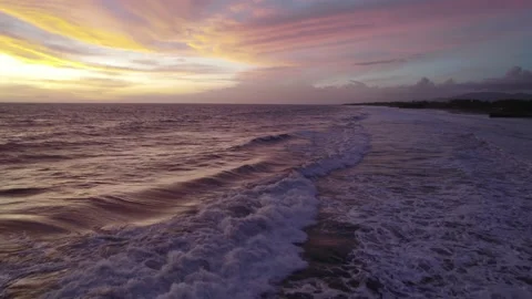 Serene Ocean Waves at Sunset with Dramatic Sky Tilt Up &amp; Track In 库存影片 237521401