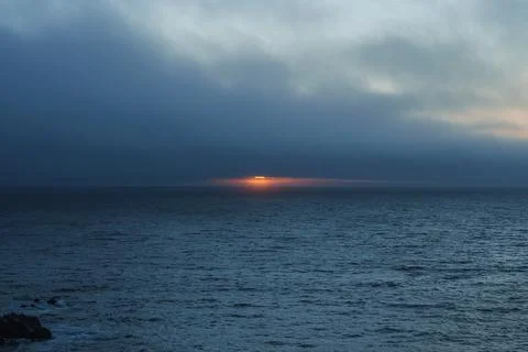 Serene Pacific Ocean Sunset with Dramatic Cloud Contrast Stock Photos