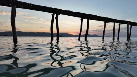 Serene Pier Sunset Reflection on Calm Sea Stock Footage 263515932