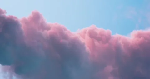 Serene Pink Clouds Gliding Through Blue Sky in Soft Light Stock Footage 329199049