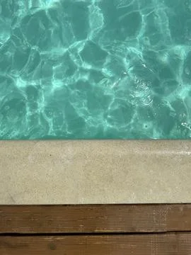 Serene Poolside with Clear Turquoise Water Stock Photos