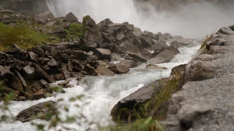 A serene river flowing gracefully through rocky terrain surrounded by misty Stock Footage 292796802