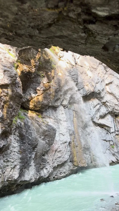 A Serene River Gracefully Flowing Through a Stunning Rocky Canyon Landscape Stock Footage 304779106