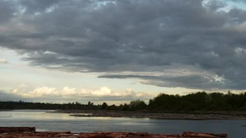 Serene River Landscape with Dramatic Cloudy Skies at Dusk Stock Footage 274463877