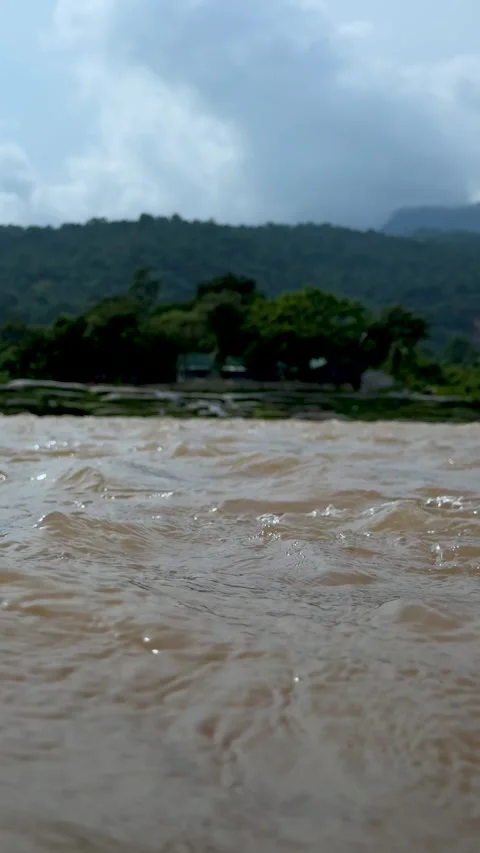 Serene river scene with lush green hills under a cloudy sky creating a tran.. Stock-Footage 338414710