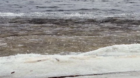 The Serene River Waves Gently Meeting the Sandy Shoreline Creates Such a Stock Footage 322758753