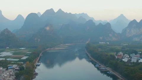 Serene river winds through karst mountains in rural china Stock-Footage 311819613