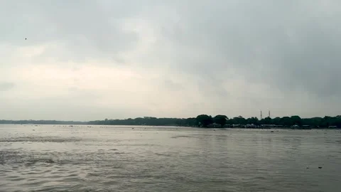 Serene riverscape under a cloudy sky with distant shoreline and subtle refl.. Stock Footage 340221622
