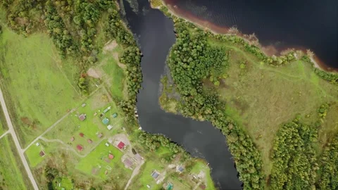 Serene Riverside Settlement, Wooden Bridges Amidst Early Fall Colors. Aerial Stock Footage 257783353