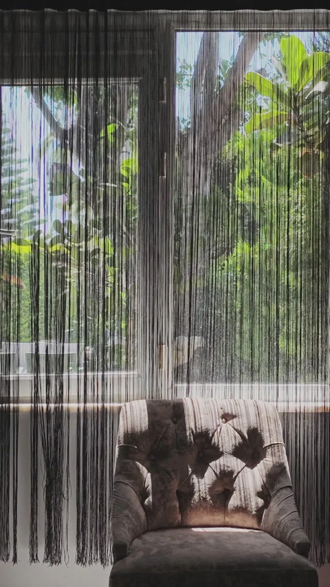 Serene room interior with sunlight casting shadows through a black string Stock Footage 346182783