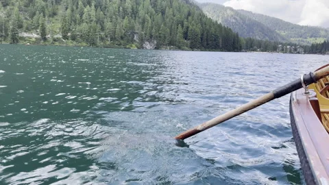 A Serene Rowing Scene on a Beautiful, Tranquil Lake Surrounded by Mountains Stock Footage 280766709