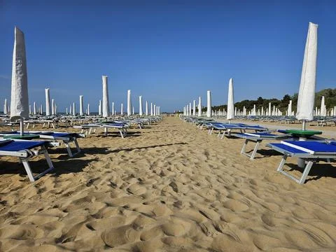 Serene Sandy Beach with Rows of Empty Umbrellas Stock Photos
