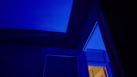 Serene scene captured from rooftop showing illuminated attic against deep Video stock 332246242
