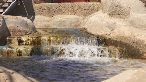 Serene Scene of Water Cascading Down Stone Steps Stock Footage 285772710
