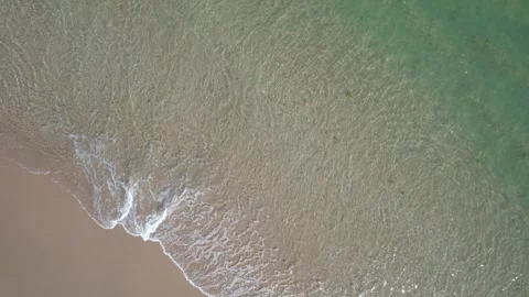 Serene Seascape from Above with a Soft Wave Lapping on the Sand. Video stock 332600201