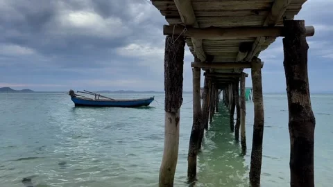 Serene Seascape, Rustic Pier and Boat Stock Footage 260162248