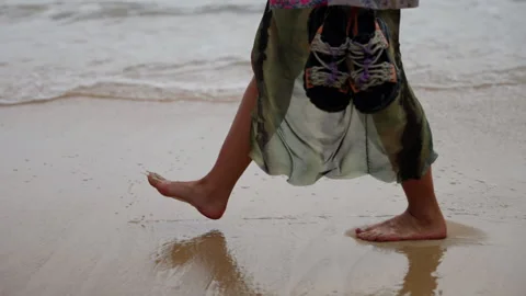 A Serene Seaside Stroll: Capturing the Tranquility of Barefoot Walking Along the Stock Footage 310060293