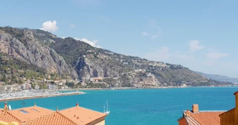 Serene Seaside Town at Midday With Clear Blue Skies and Tranquil Waters Stock Footage 271574419