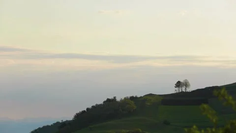 Serene skies: Sunset clouds over verdant landscape Stock Footage 245706522