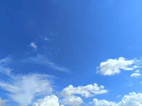 Serene sky with fluffy clouds, perfect for backgrounds, websites, naturethemed d Stock Photos