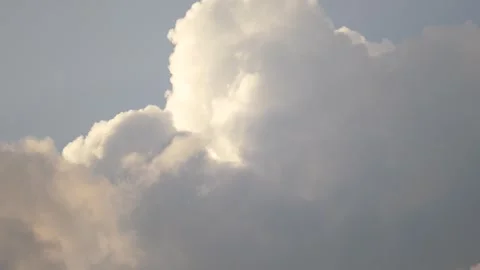 Serene Sky with Fluffy White Clouds and Sunlight Peeking Through Stock Footage 264348250
