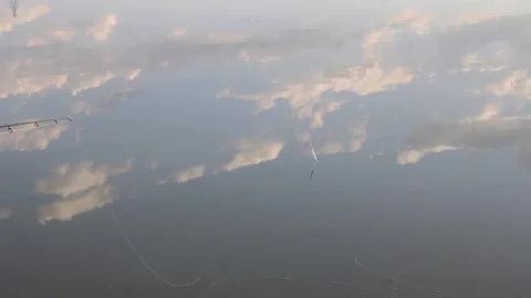 Serene Sky Reflection on Calm Water Surface Stock Footage 312463958