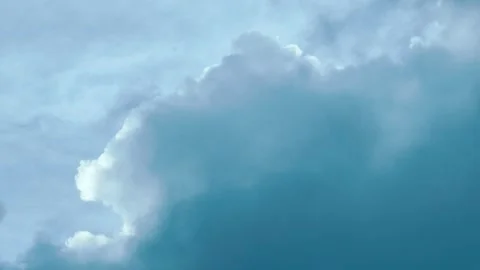 A serene sky scene with dynamic cloud movement across a clear blue backdrop. Stock Footage 338266276